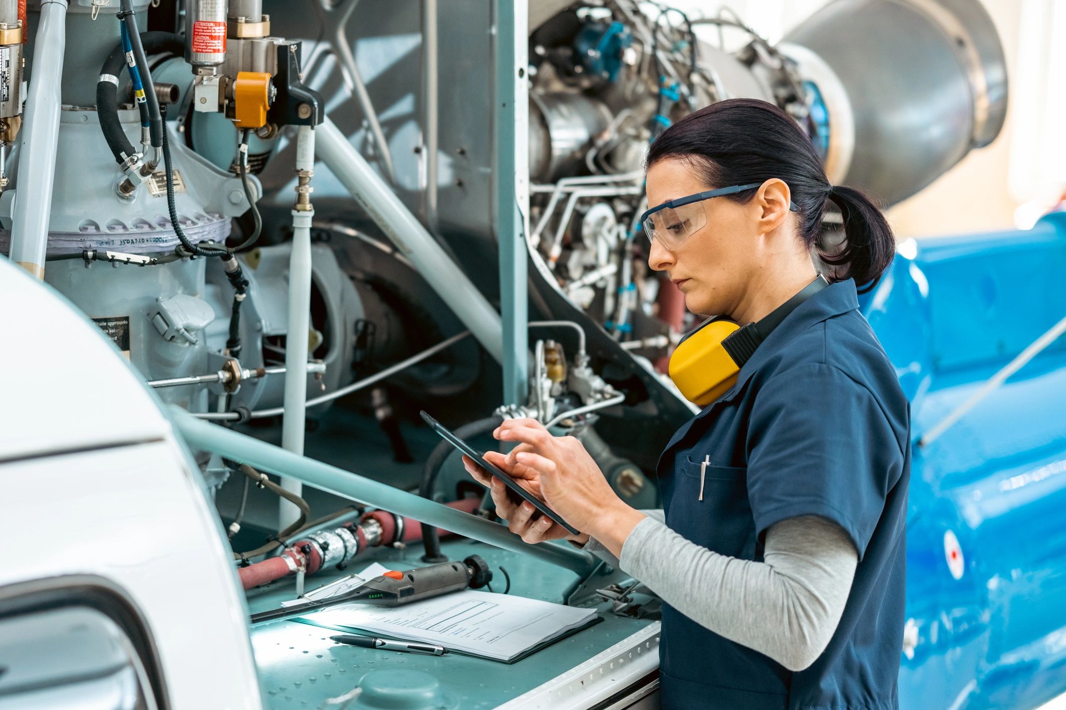 Technician reviewing a checklist on a tablet in a technical environment